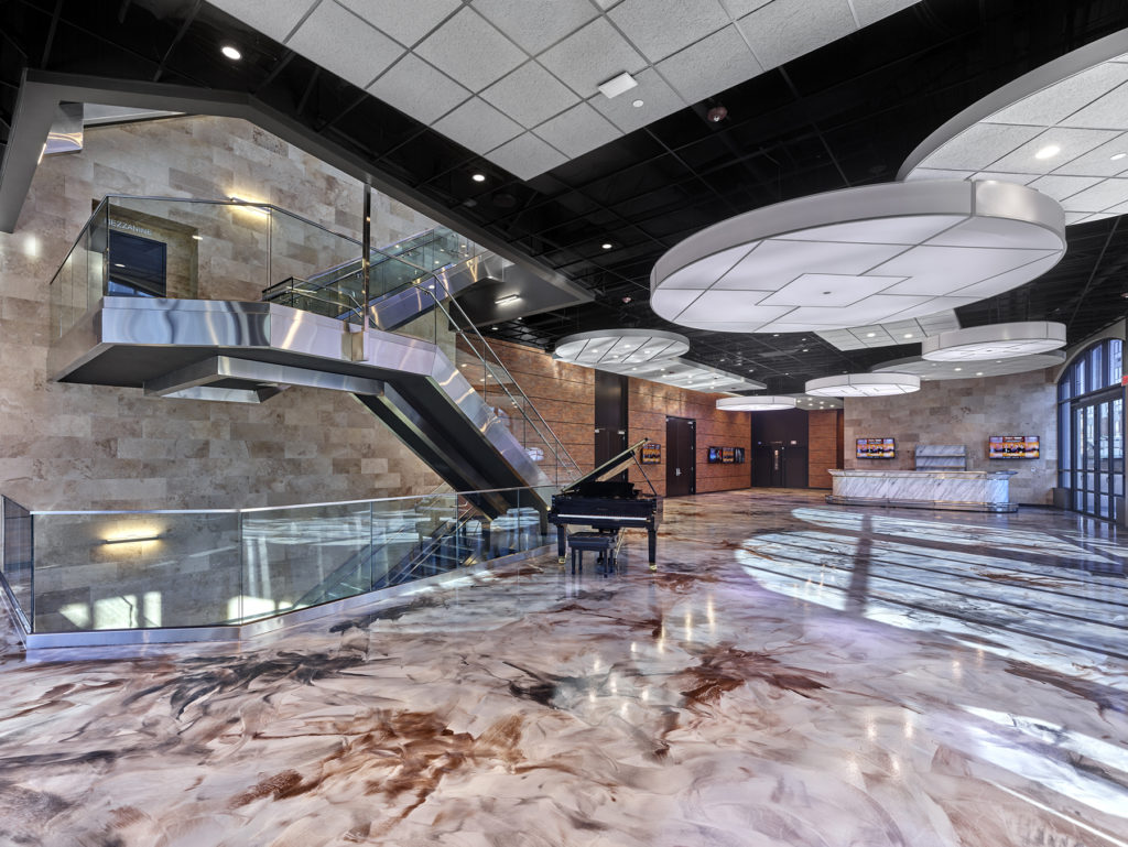 Expansive marble lobby with baby grand piano | carteret performing arts center