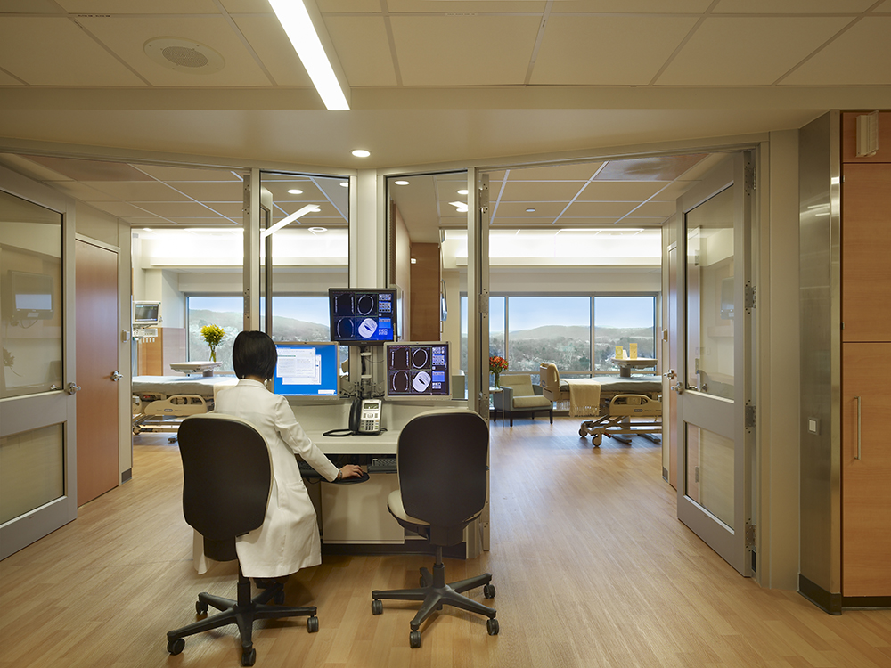 nursing station and patient rooms with glass curtainwall