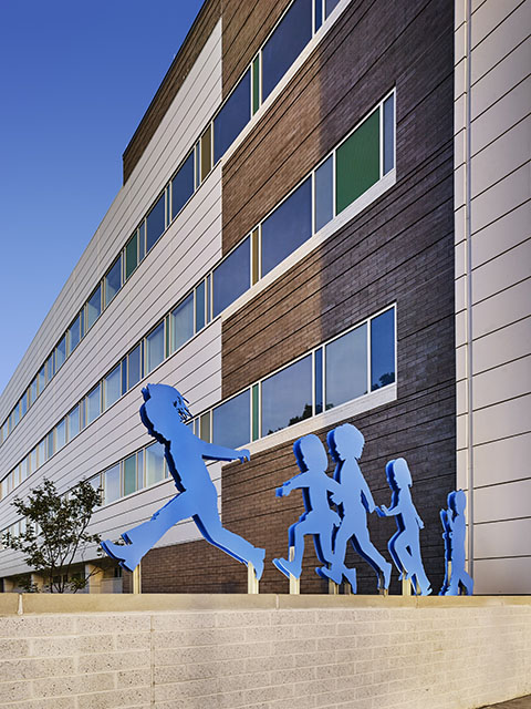 blue sculpture of silhouettes of running children